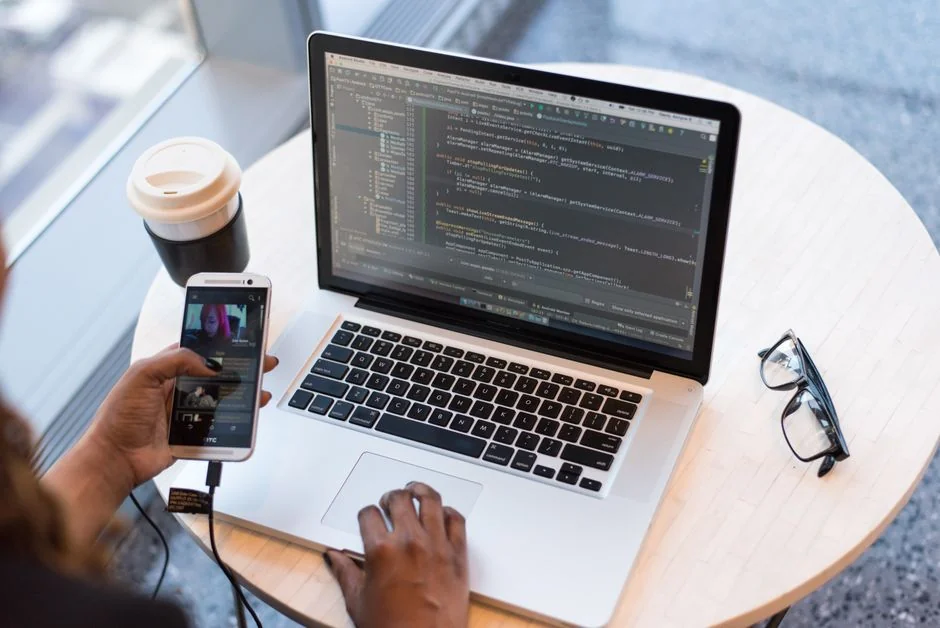 A person using a laptop to browse stock photo websites. Freelancing work in a cozy setting.